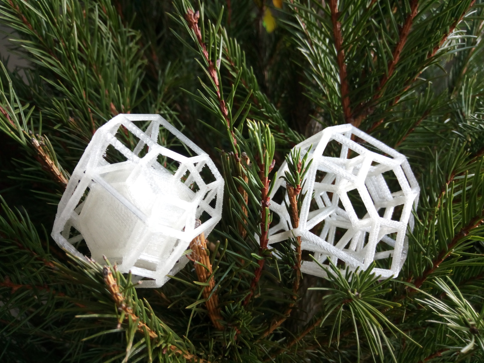 deux vues d'un même polytope imprimées en 3D et posées sur un sapin